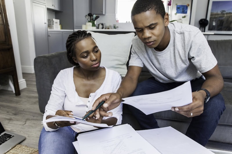 Young couple at home working on their finances together.